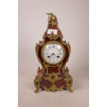 A faux tortoiseshell and brass mounted French mantel clock, the porcelain dial in Roman numerals