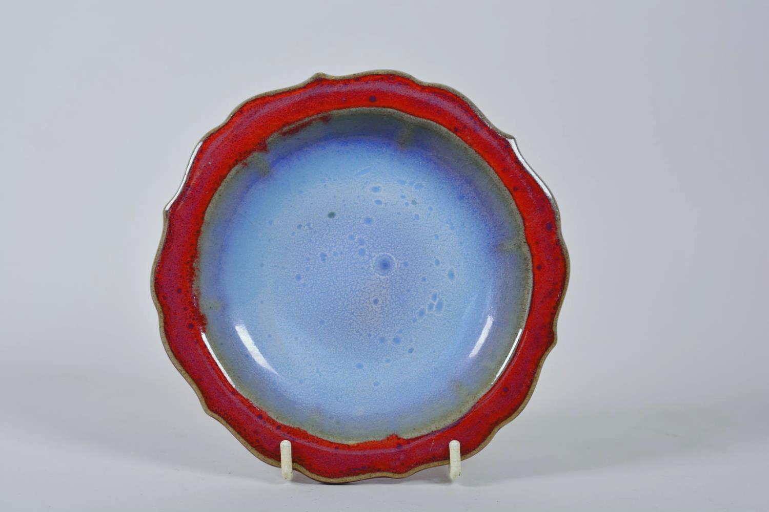 A Chinese Jun ware dish on tripod feet with a lobed rim and flambé glaze, mark to base, 6½" diameter