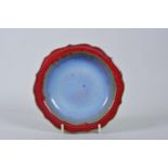 A Chinese Jun ware dish on tripod feet with a lobed rim and flambé glaze, mark to base, 6½" diameter