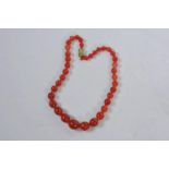 A carnelian agate variegated bead necklace, hand knotted with a brass clasp, 15" long