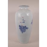 A tall Korean porcelain vase with ribbed decoration painted with flowers and branches, 21" high