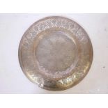 An Islamic cast brass charger with incised decoration, 21" diameter