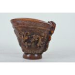 A Chinese faux horn libation cup with carved kylin decoration, mark to base, 5" high