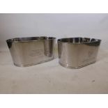 A pair of large chrome plated champagne buckets, decorated with engraved quotes by Lily Bolinger and