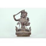A Tibetan bronze of Buddha seated on a lotus throne, 12½" high