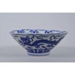 A Chinese blue and white porcelain bowl with a lobed rim and dragon decoration, 6 character mark