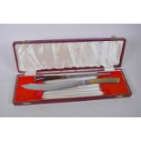 A horn handled carving knife and steel, 14" long, in fitted box, A/F