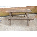 A weathered teak picnic bench, in need of TLC, 59" x 54" x 27" high