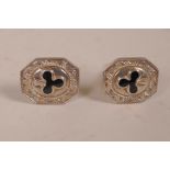 A pair of silver cufflinks, set with enamel three leaf clovers