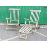 A pair of teak garden sun loungers, one footrest missing