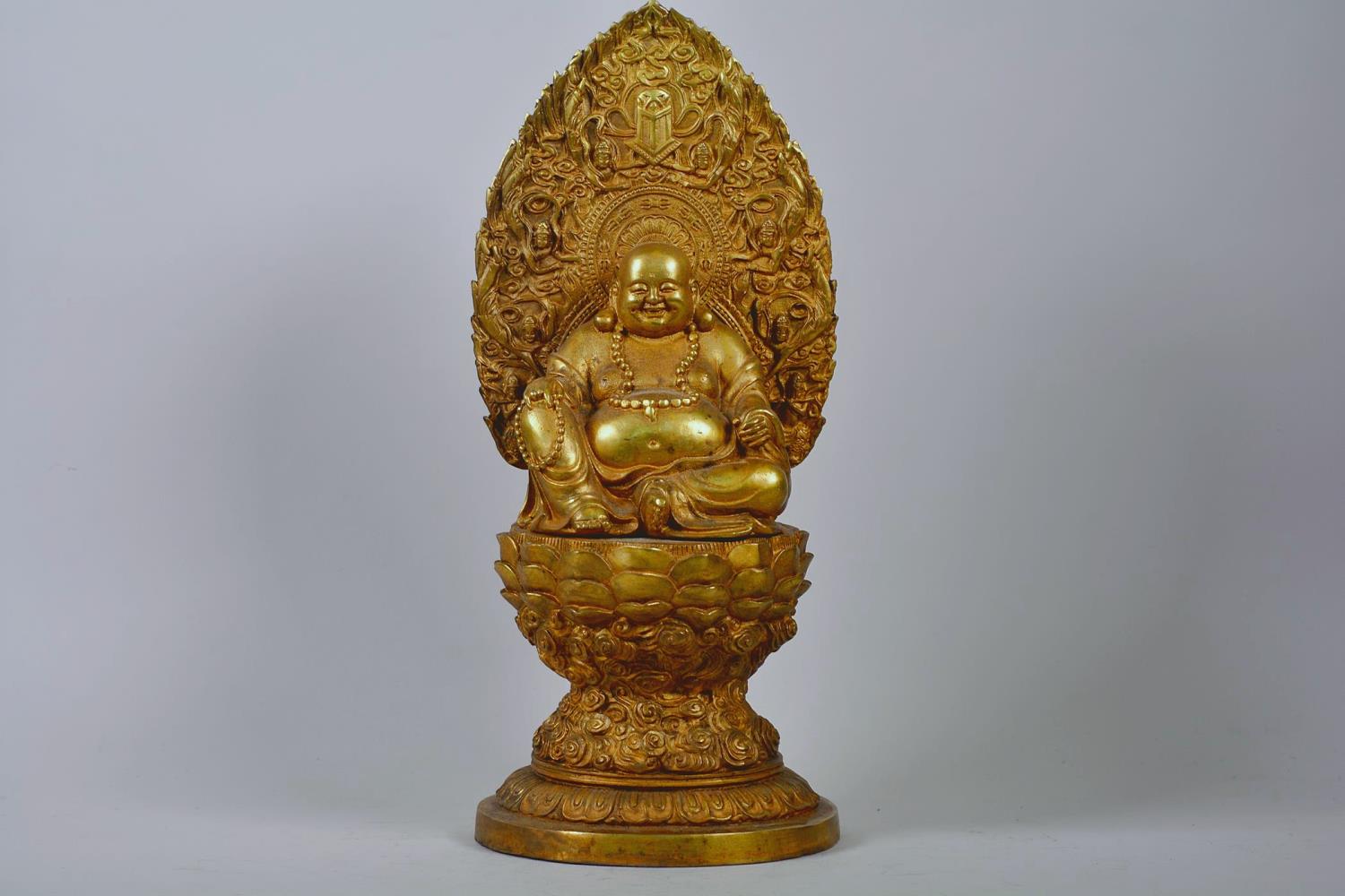 A large Chinese gilt metal Buddha seated on a lotus throne, impressed 4 character mark to base,