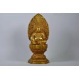 A large Chinese gilt metal Buddha seated on a lotus throne, impressed 4 character mark to base,