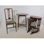 A nest of four mahogany occasional tables with oval shaped tops, 20" x 25", an inlaid sidechair, and