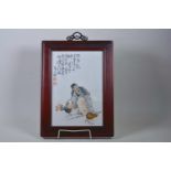 A Chinese polychrome porcelain panel decorated with a bearded sage, mounted in a hardwood frame, 13"