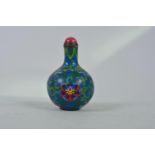 A Chinese cloisonné snuff bottle with lotus flower and auspicious symbol decoration, 3" high