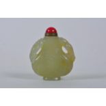A Chinese celadon jade snuff bottle with two carved kylin handles, 2½" high