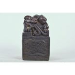 A Chinese filled bronze square form seal decorated with a kylin and dragon turtle, 3" x 3", 5" high