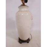 A Chinese vase ceramic lamp base with a cream ground and faux dog mask handles, 19½" high x 8" wide