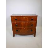 A Regency figured mahogany chest of three long drawers with crossbanded top, original bun handles