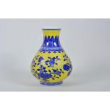A Chinese yellow ground porcelain vase with blue and white pomegranate tree decoration, seal mark to