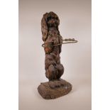 A Black Forest carved wood stick stand in the form of a spaniel, 26½" high