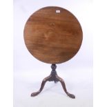 A good Georgian mahogany tilt top table with one piece top, raised on a turned and carved column and