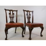 A pair of mahogany Chippendale style side chairs, with brass studded leather covers, bearing label