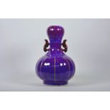 A Chinese purple flambé glazed pottery garlic head shaped vase with two handles and ribbed sides,