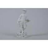 An C18th Derby biscuit porcelain figure of a man reclining against a tree, in the style of
