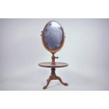 A Victorian mahogany table top make up stand with adjustable height oval mirror in crossbanded frame