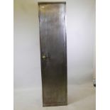 A steel single door cabinet with brass handle and lock with key, 18" x 18" x 72"