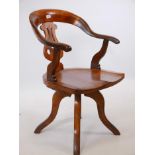 A Victorian fruitwood and oak revolving office chair, with shaped and elm seat, and pierced splat