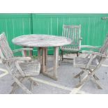 A set of three teak folding garden chairs and drop leaf table, table A/F