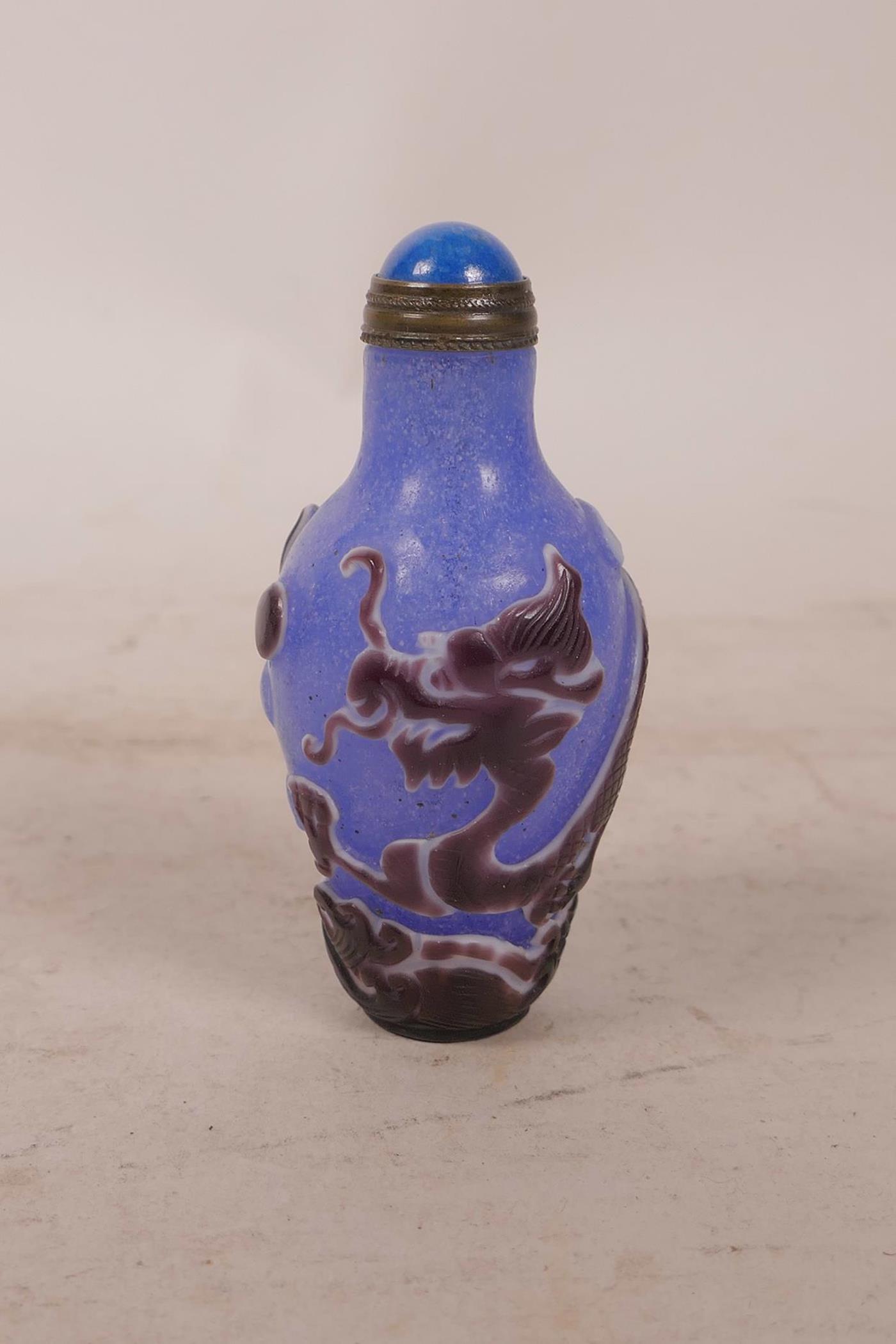 A Chinese carved Peking overlay glass bottle decorated with a dragon, 2½" long