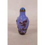 A Chinese carved Peking overlay glass bottle decorated with a dragon, 2½" long