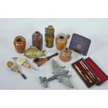 A box of collectables including a brass model Mosquito aircraft, Royalty cigarette tin, drawing set,