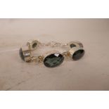 A silver and faceted oval bead set bracelet, 7" long