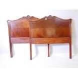 A pair of mahogany bed-heads with carved crests, 41" x 43"