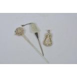 A Chinese jade mounted white metal hairpin with Buddha decoration, together with a white metal