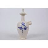 An Oriental white pottery pourer with blue and white decoration, inscribed mark to base, 9" high