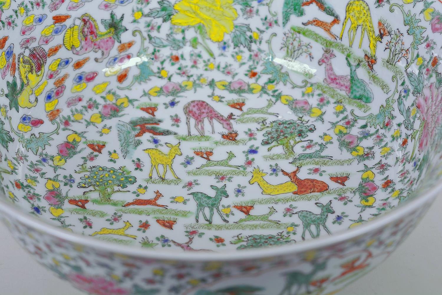 A large Chinese porcelain bowl decorated with deer, mythical beasts and flowers in bright enamels, - Image 3 of 9