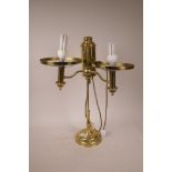 A two light adjustable brass desk lamp, 22" high