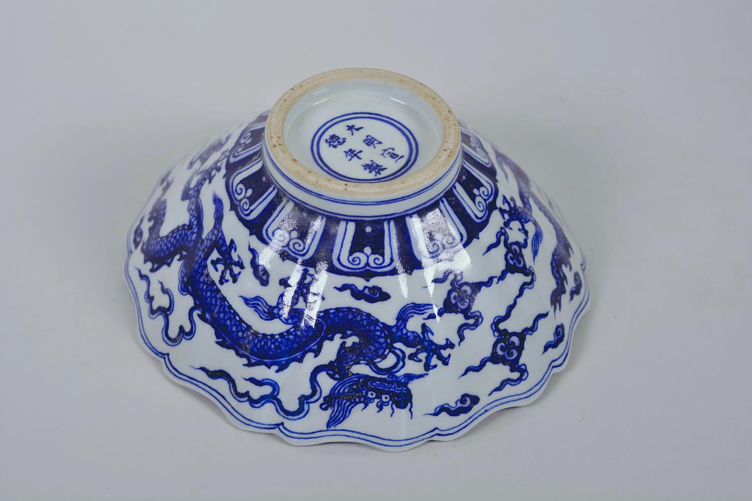 A Chinese blue and white porcelain bowl with a lobed rim and dragon decoration, 6 character mark - Image 9 of 11