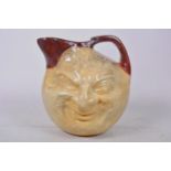 A Martin Brothers style composition face jug, 7" high