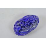 A Chinese carved lapis pendant with goldfish decoration, 3" long
