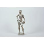 A Russian metal sculpture of a physically strong Soviet woman holding a football, symbolising the