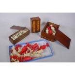 A box of vintage games including two dyed bone part chess sets, crib board and dominoes