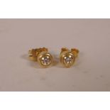 A pair of 9ct yellow gold set diamond stud earrings