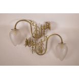 A pair of brass wall lights with tulip shaped frosted and cut glass shades, 14" long