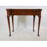 A Georgian red walnut fold over card table with a single drawer and counter wells, 36" x 18"